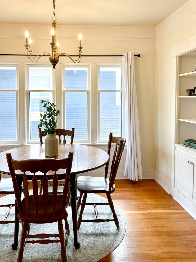 Occupied home staging project by Modern Mollusk featuring a traditional dining room with cream walls and organic decor.