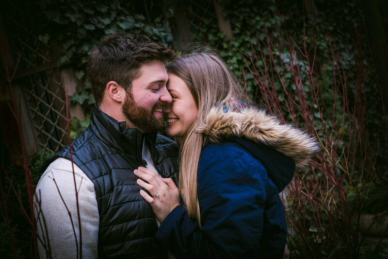 A girl says yes to her boyfriend's proposal in New York City at Bryant Park.