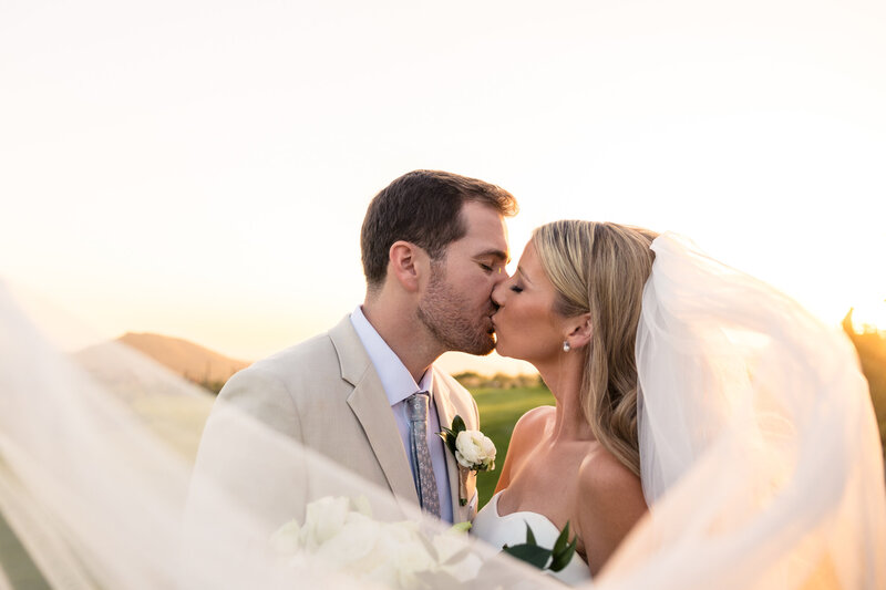 couple kissing under arch in utah