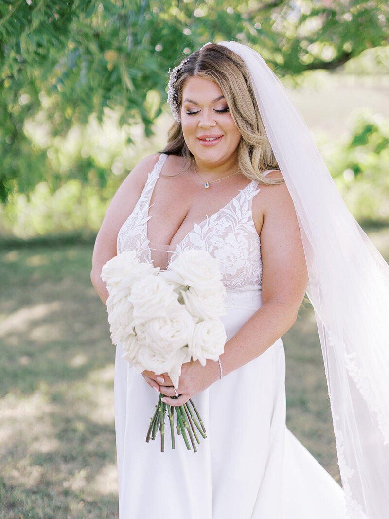 Bride With Wedding Dress and Creamy White Floral Bouquet