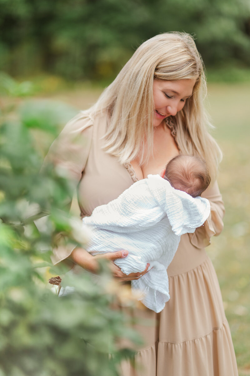 Mother nursing her newborn baby outside by york pa photographer