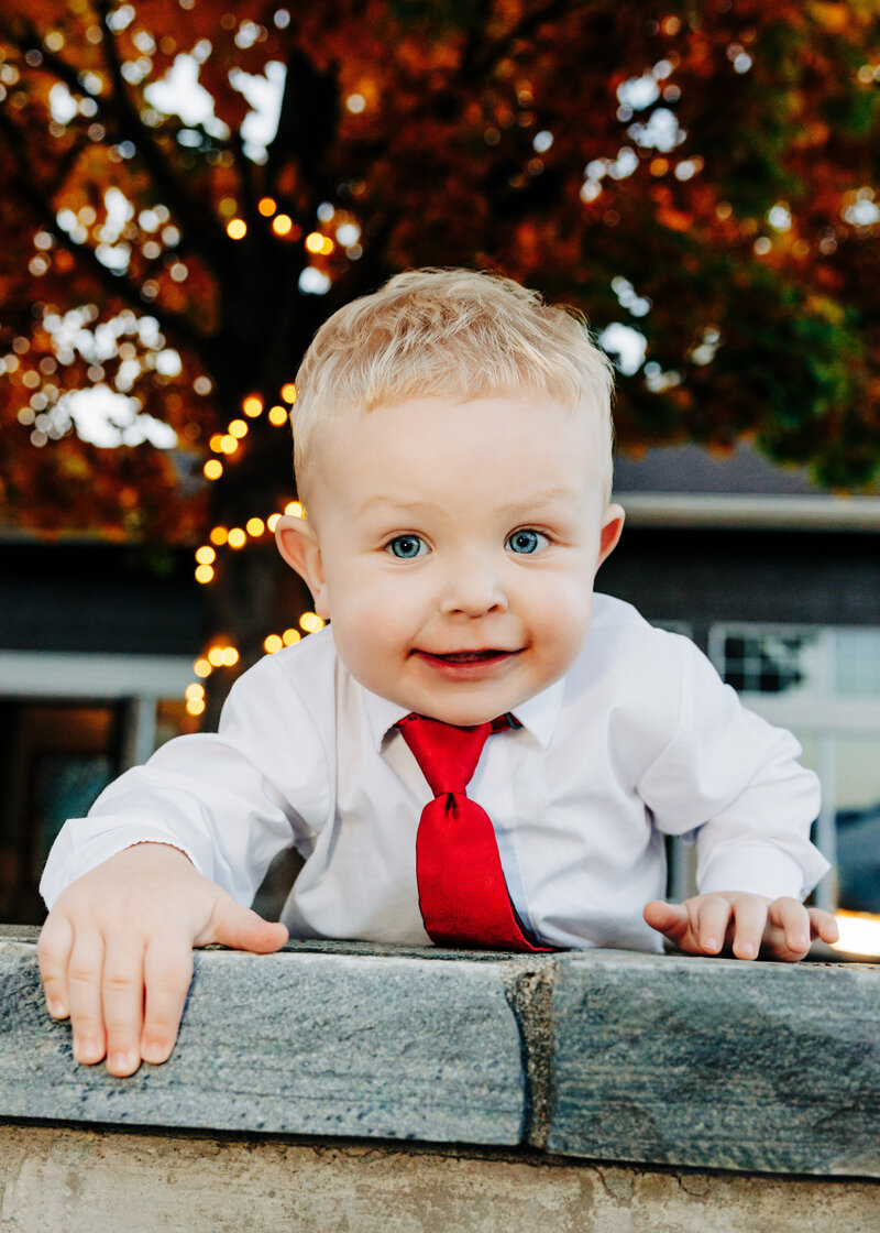 Little boy ring bearer playing outside at Kwataqnuk Resort in Polson, MT