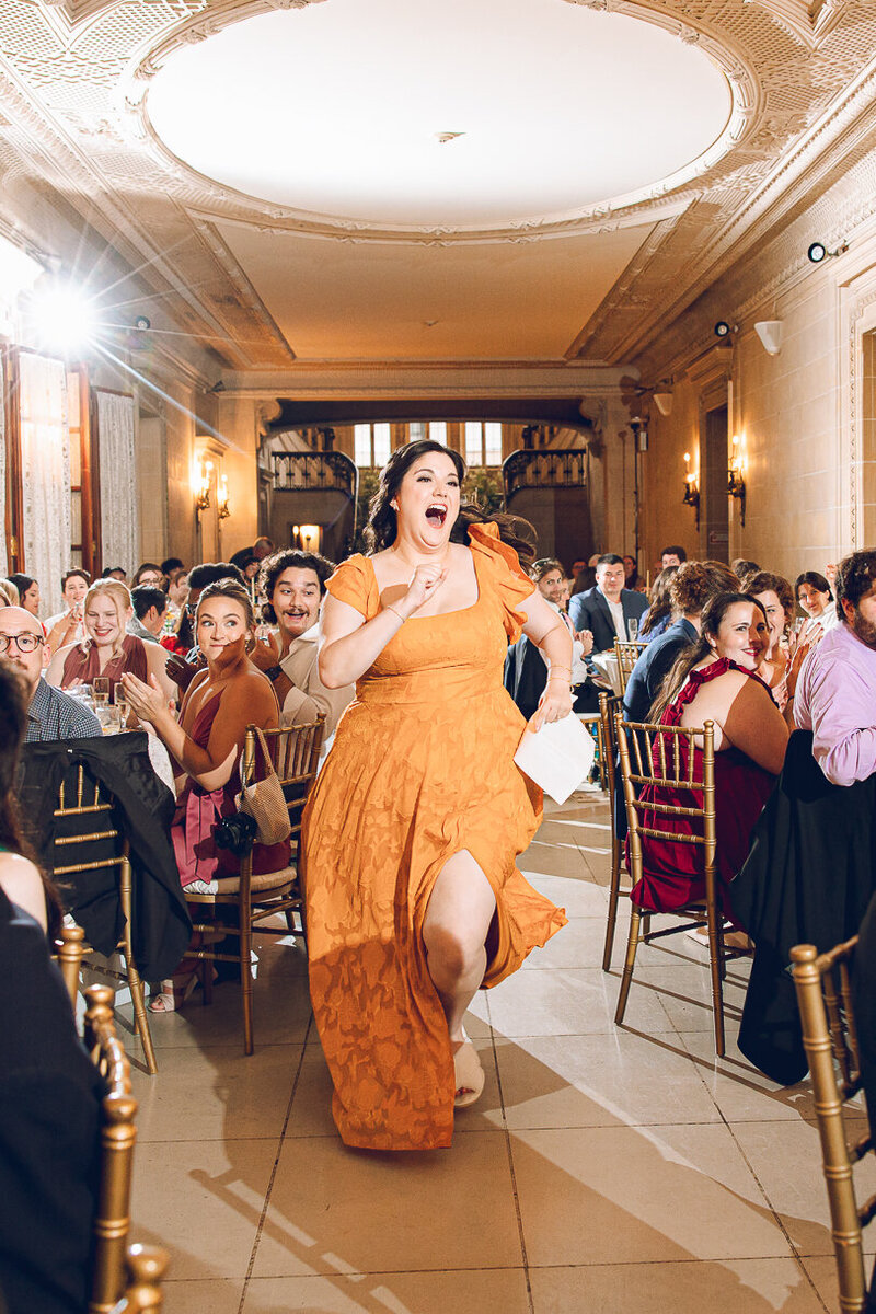 A bridesmaid rushes to give her speech at a queer wedding at the Armour House in Lake Forest