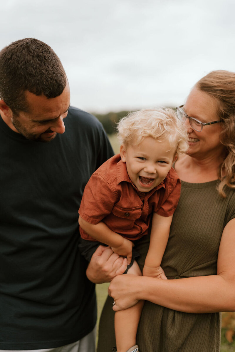 family poses for family photos in peoria il