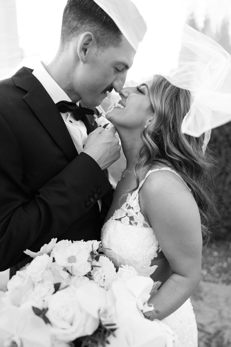 Photo of Bride and Groom kissing under a veil photo taken by Pittsburgh Wedding photographer, Sara Haines