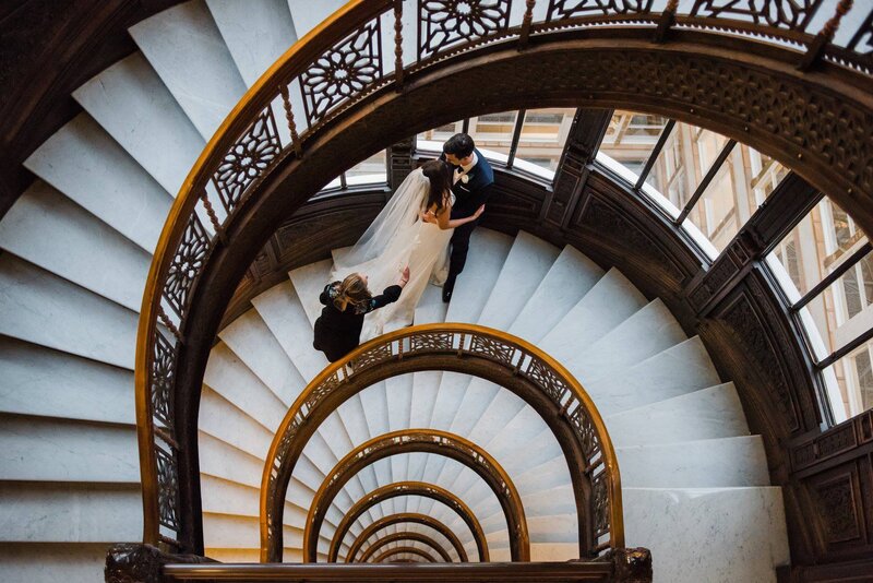 A candid behind-the-scenes photo of Chicago wedding photographer Ashley guiding a couple on their wedding day, capturing authentic and timeless moments.