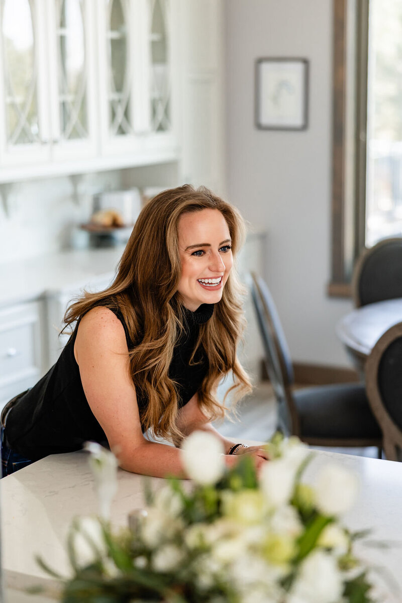 JaCee Petko, Christian life coach, leaning against her counter and smiling