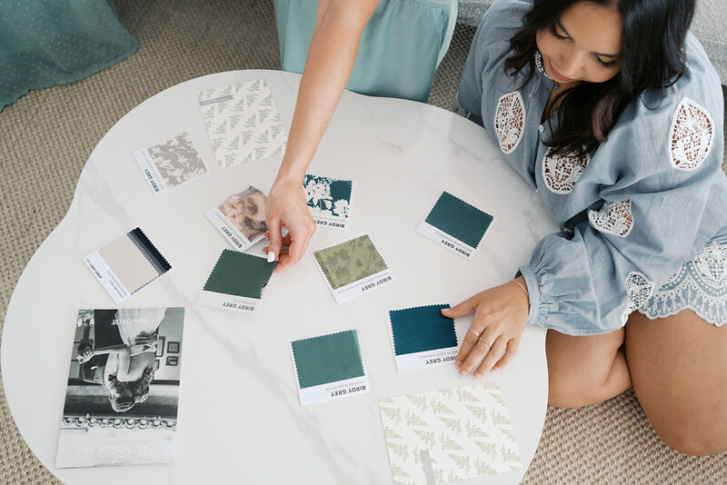 Raleigh wedding planners looking at color swatches on a table