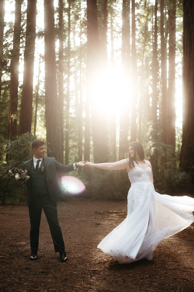 Henry Cowell Redwoods State Park Wedding: Sun rays burst through the trees and shine on a bride and groom