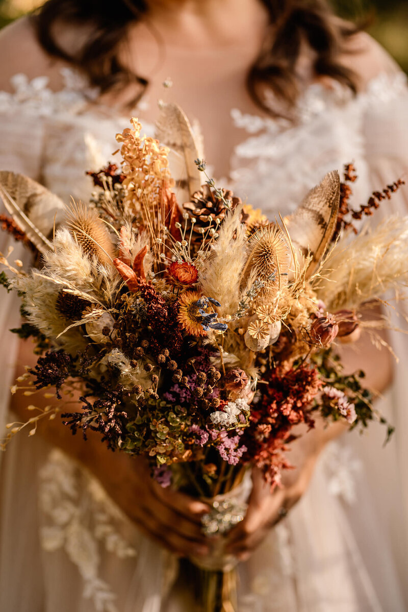 A bride holds her bouquet of dried florals during her Oregon elopement.