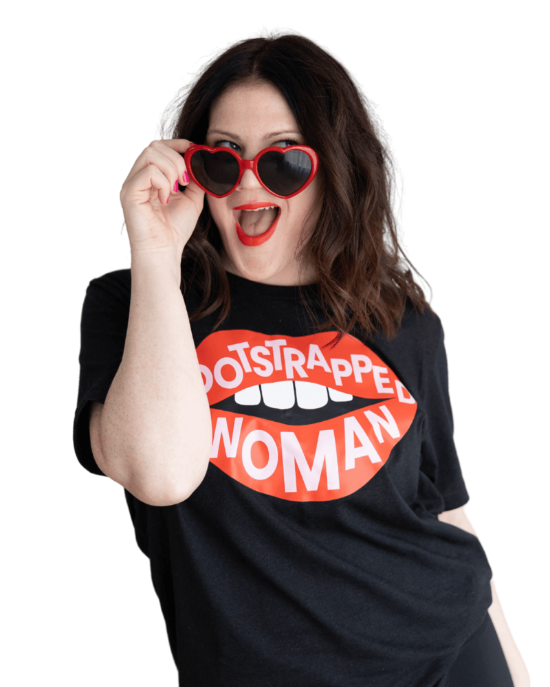 Emily confidently wearing red sunglasses and a black shirt with "bootstrapped woman" written on it.