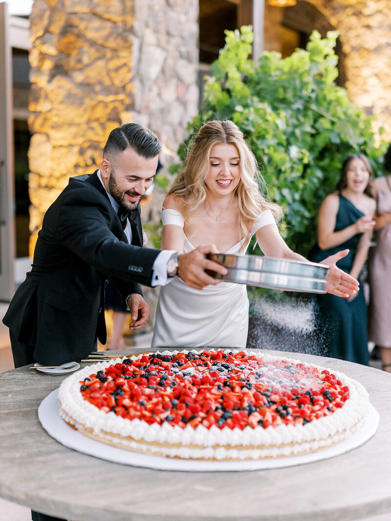  bride and groom, build an Italian cake during their wedding reception at Niner winery in Paso Robles