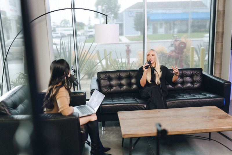 business speaker and 7 figure business mentor natasha zoryk getting her microphone adjusted for filming