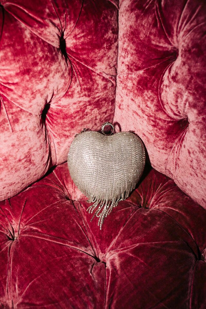 heart shaped beaded purse on pink velvet couch in the marie antoinette room at dear irving gramercy