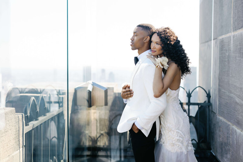 luxury wedding photo of bride and groom on city balcony