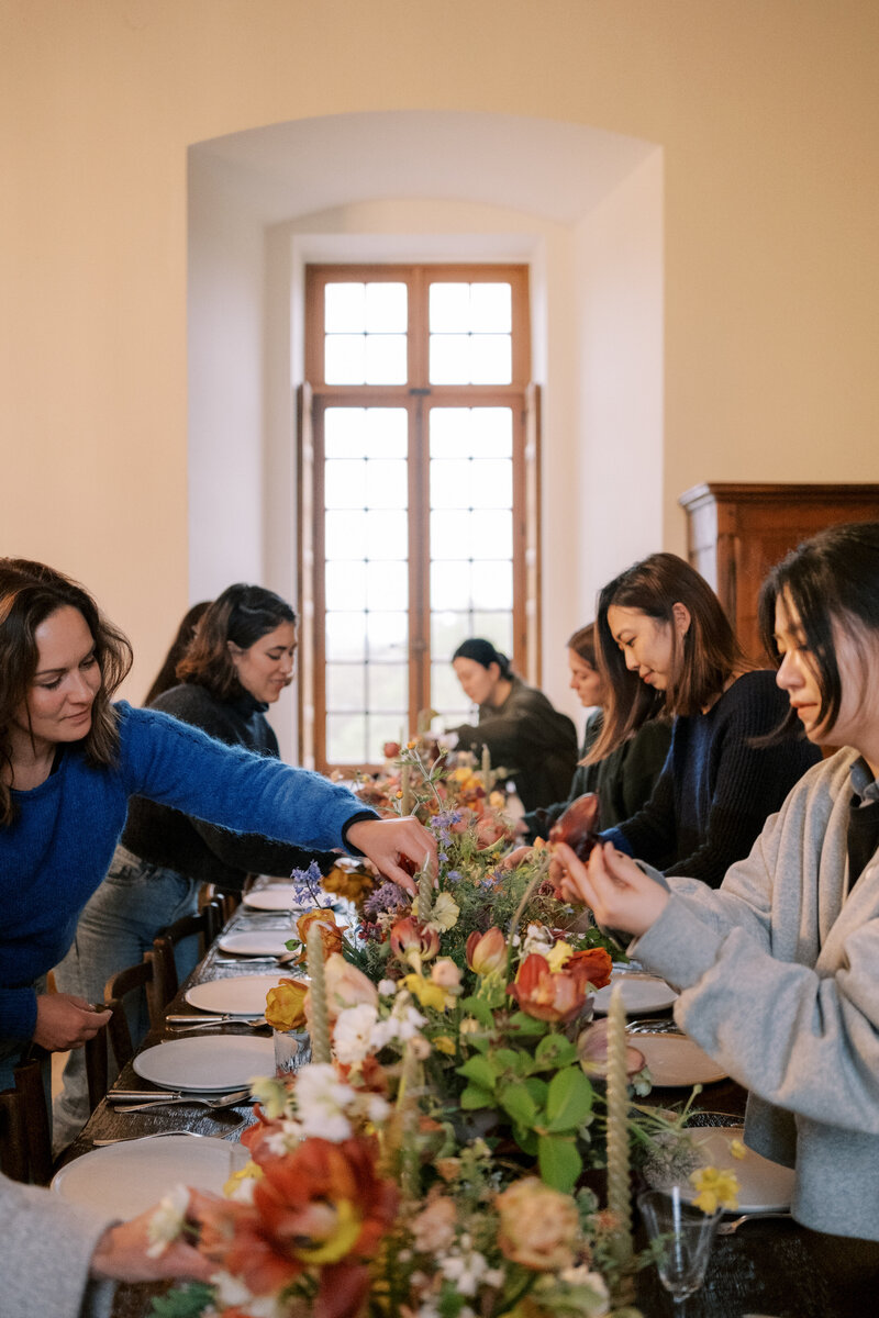 Florists learn how to arrange flowers at a workshop.