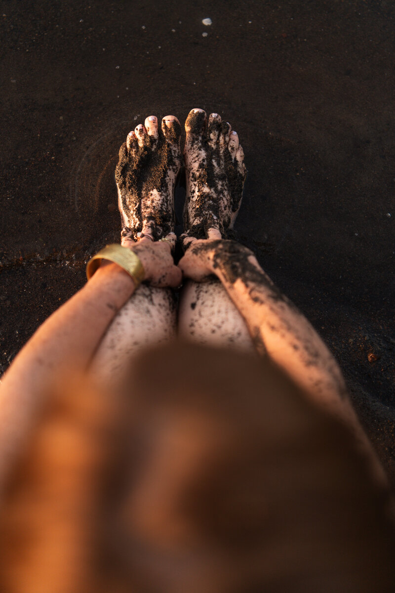 yoga teacher's feet and legs in the river