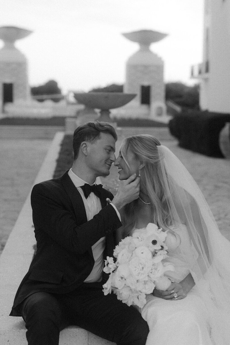 Bride and groom going in for a kiss in front of Gulf Green