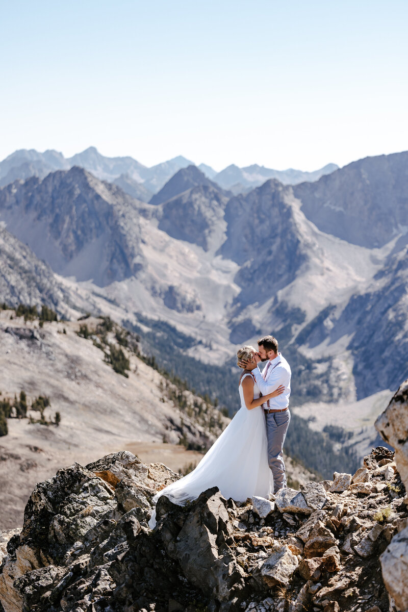 A couple looking into each others eyes laughing in the Sawtooth mountains in Stanley, Idaho