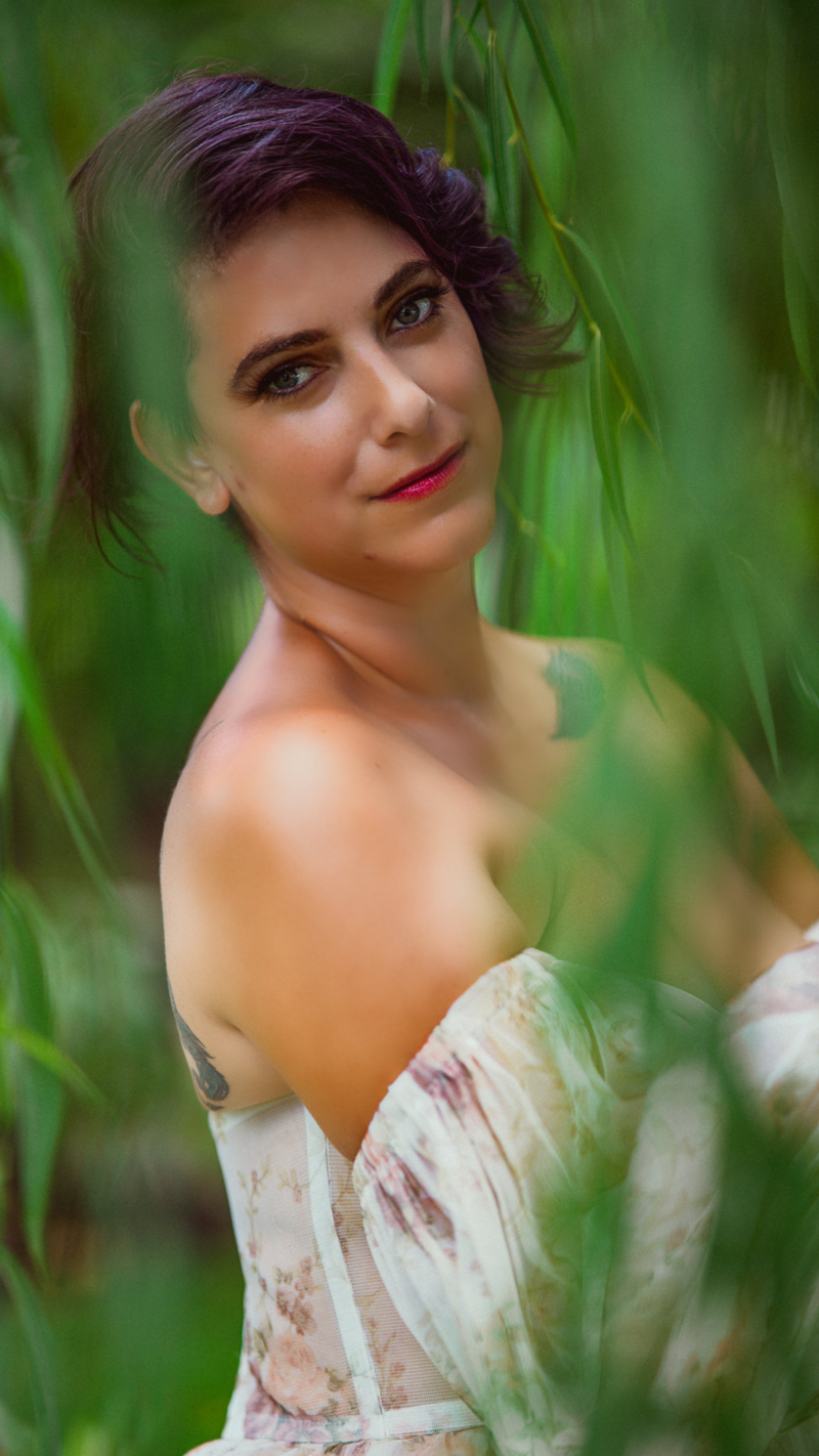 Stephanie Perry, photographer in Lakeland, Florida, dancing at Hollis Gardens wearing floral gown.