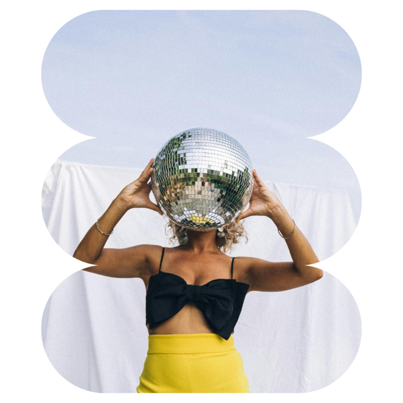 Disco ball held up to cover face of a woman