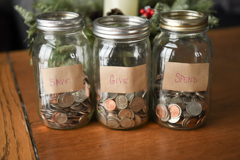 Jars of money with labels "Give", "Save", "Spend"