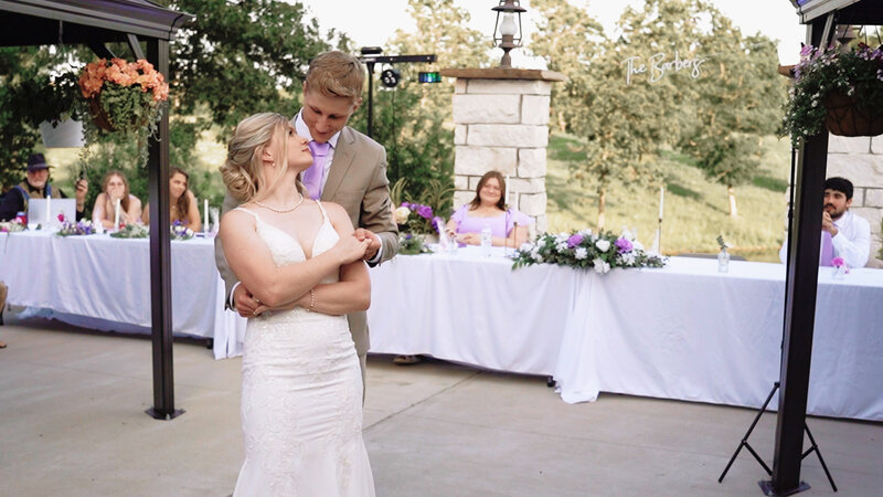 Bride and groom sharing their first dance outdoors at a Missouri wedding, photographed during golden hour.