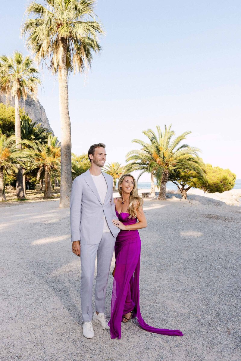 Bride and groom portrait before the pre-wedding event, with palm trees in the background.