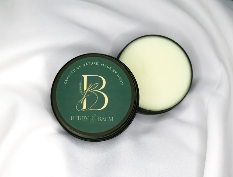 Berry & Balm magnesium body balm in tin container with natural backdrop