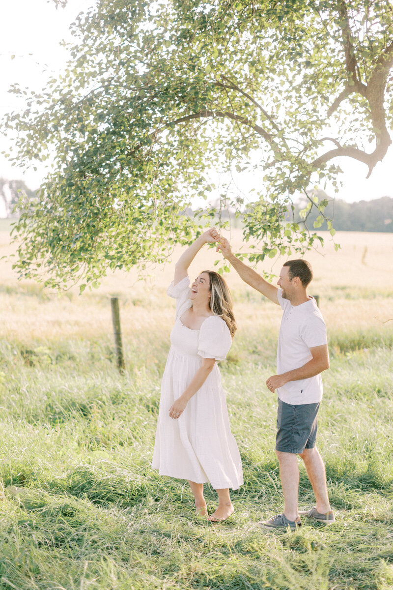 Couple dancing together in a farm field