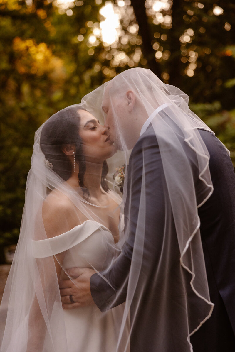 bride and groom kissing with confetti