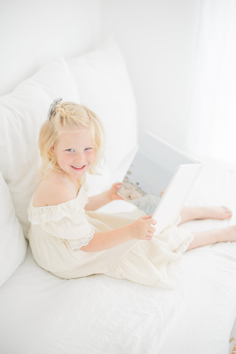 Deborah Jossick, the talented Fairfield photographer behind Oak & Lore Studio, smiles warmly in a beautifully lit portrait. Her passion for capturing timeless maternity, newborn, and family moments shines through in her elegant and heartfelt photography