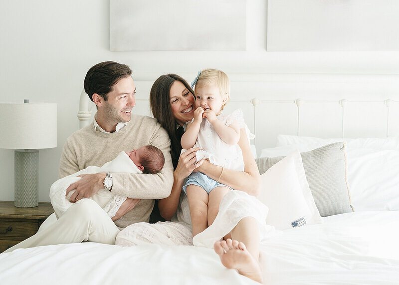 family photographed in home on st simons island with their newborn baby boy and toddler sister