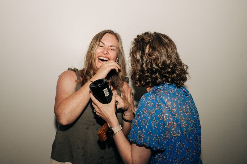 wedding guests laugh at candid moment