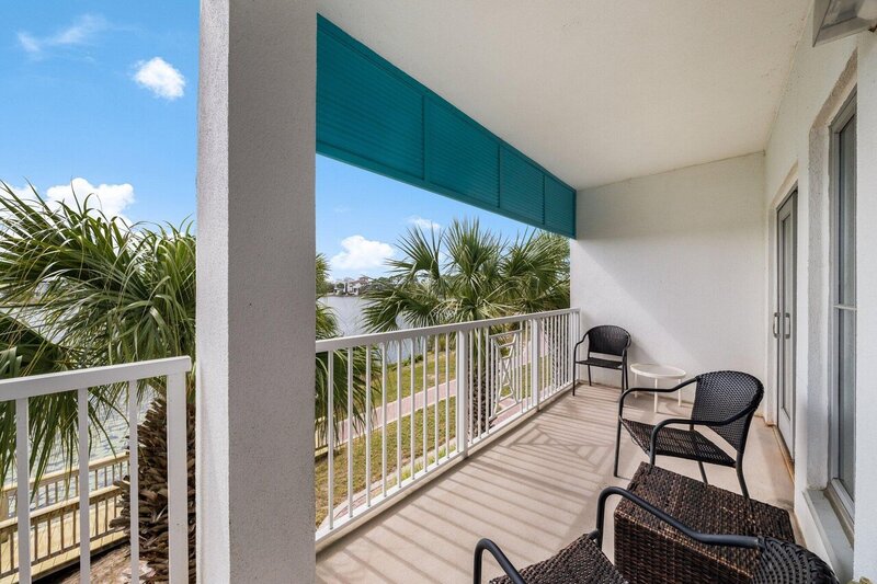 balcony overlooking lake with wicker chairs