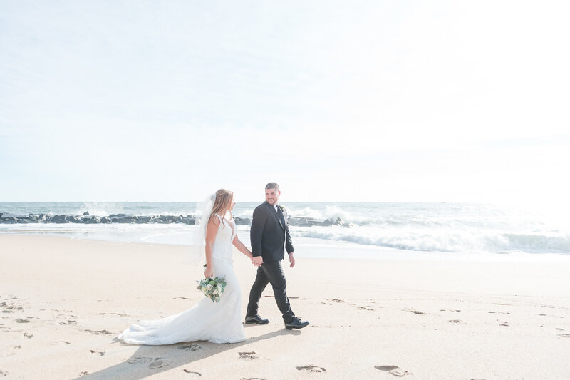 Bride and Groom walk the beach in Asbury Park during their bridal portrait session.