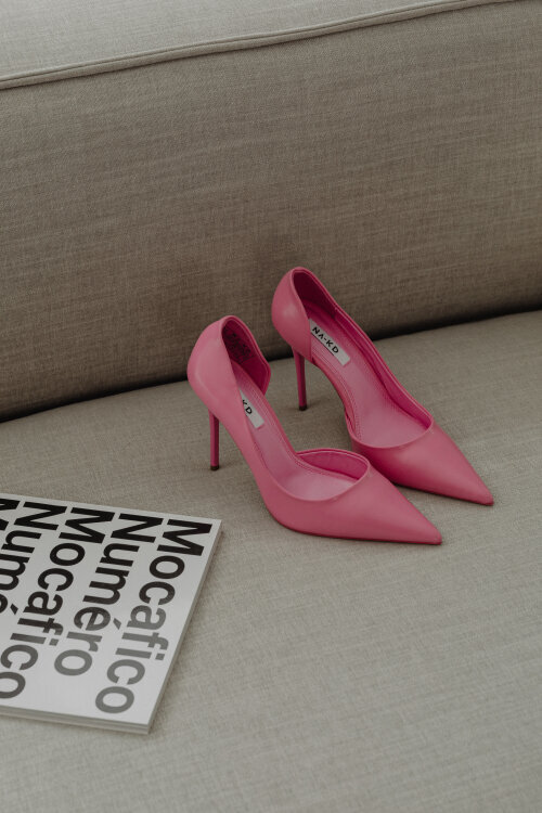 pink heels on a beige sofa