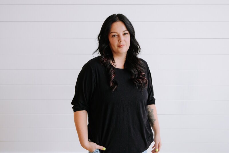 Marketing coordinator in black lace top and orange skirt at The Gem Event Centre in Canmore