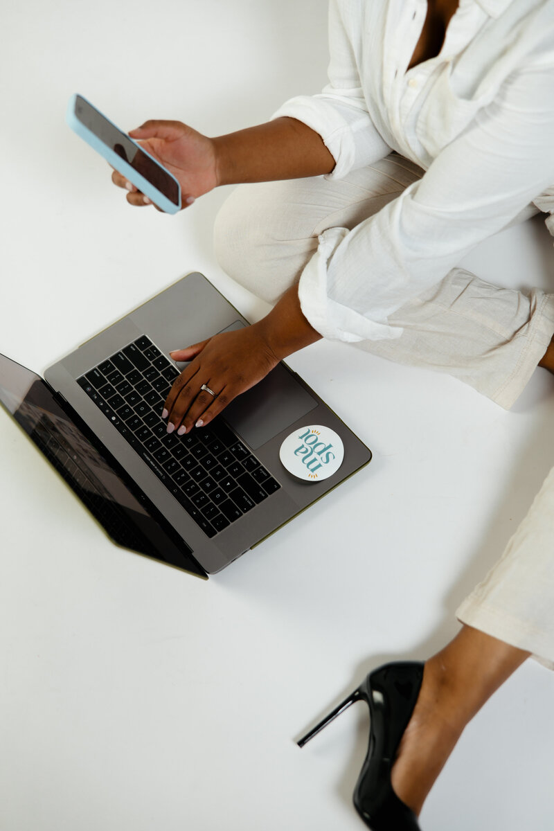 women sitting on floor with computer