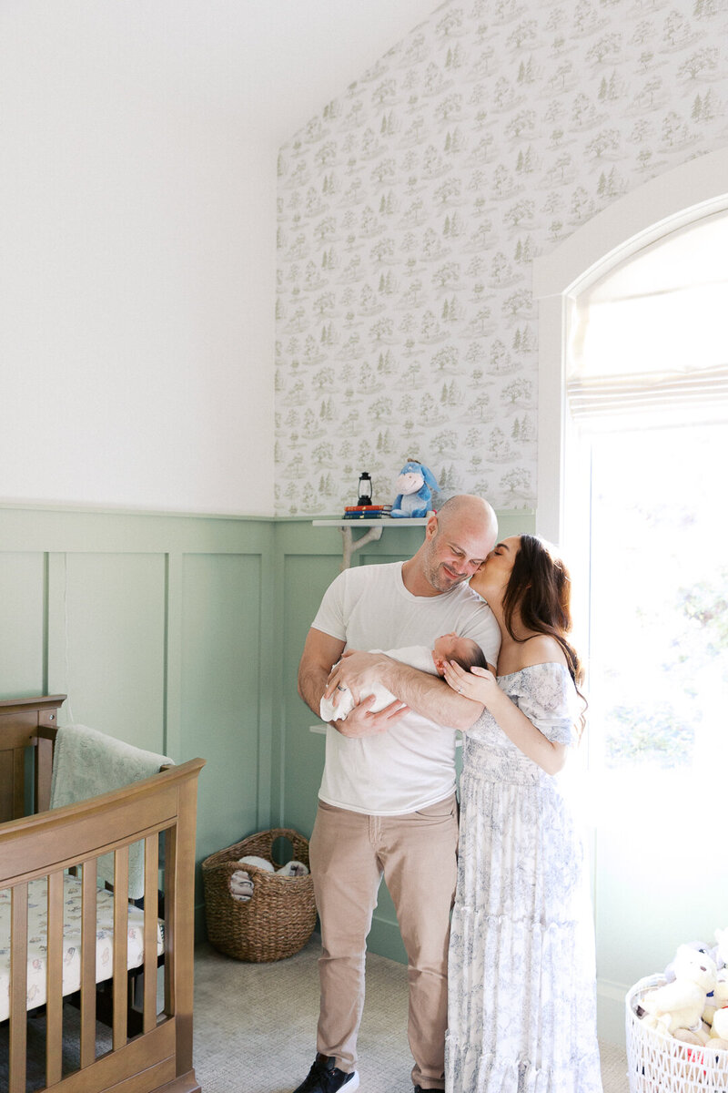 expecting mama holding belly sitting in the lavender field taken by Sacramento Newborn Photography Kelsey Krall