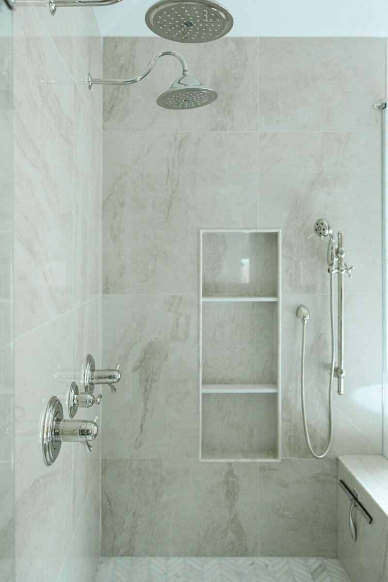 Luxury primary bathroom design in Milton, Georgia featuring a walk-in shower, freestanding tub, and elegant finishes by Megan Paterson Interiors.
