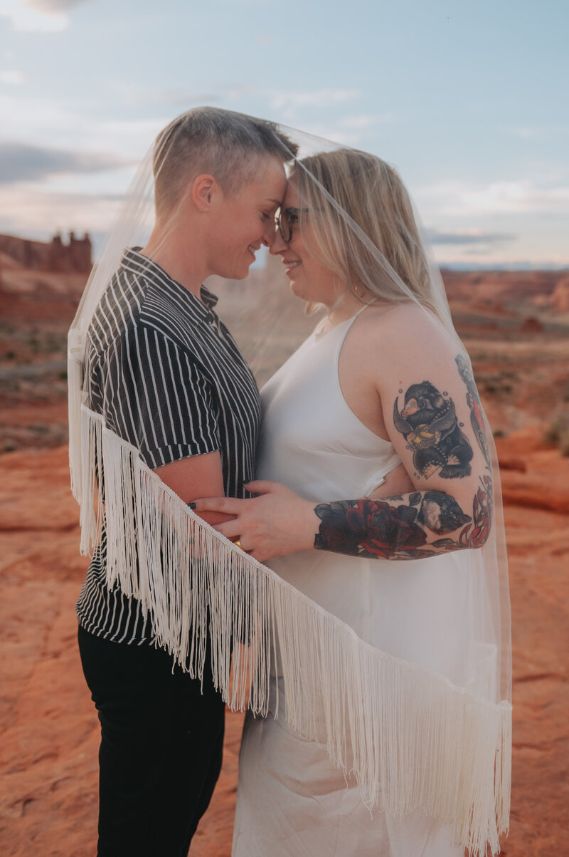 A couple leans in, forehead to forehead