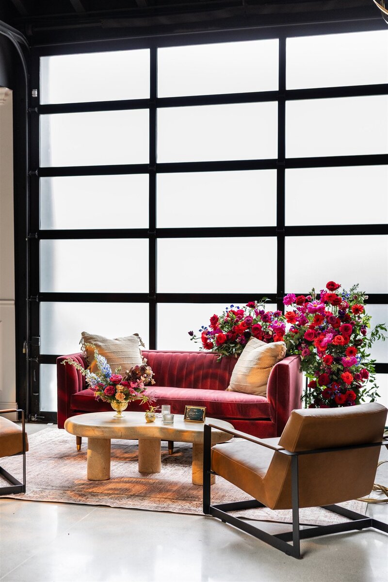 in-house lounge vignette in cocktail hour space, added floral design element overflowing