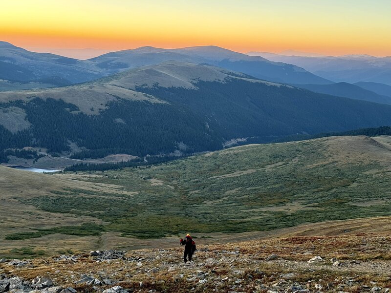 hiker in mountains with sunset