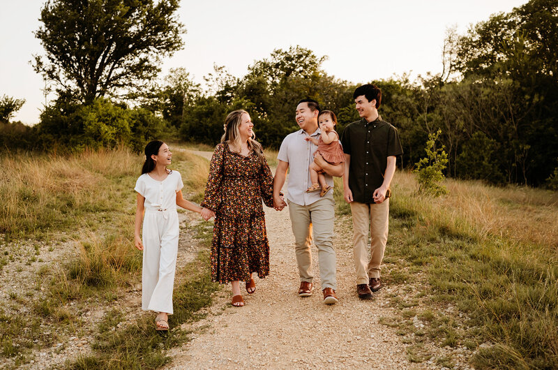 family at murrell park being photographed by Paula Goforth wearing soft tones