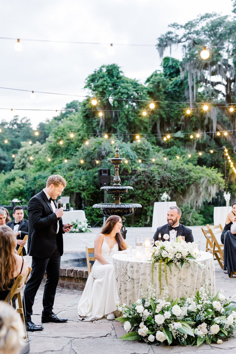 bride and grom laughing during outdoor reception at legare waring house
