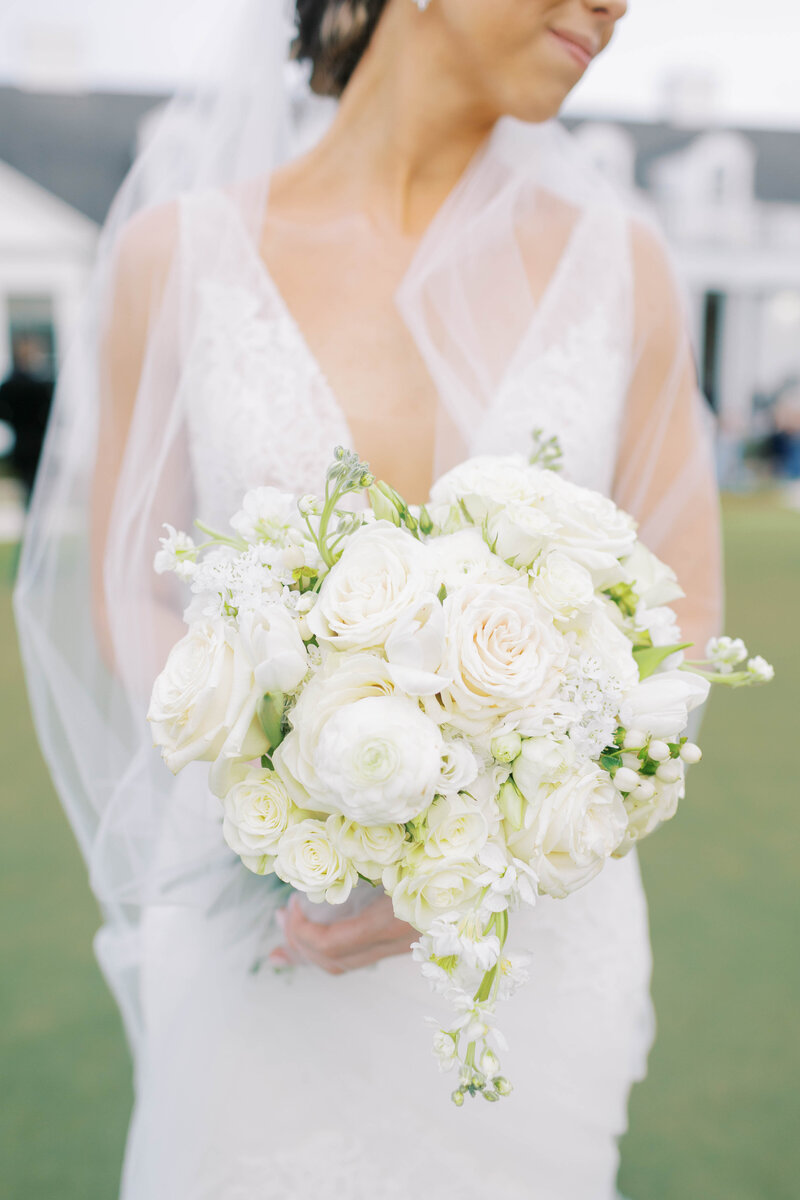 Bride standing holding her wedding boquet