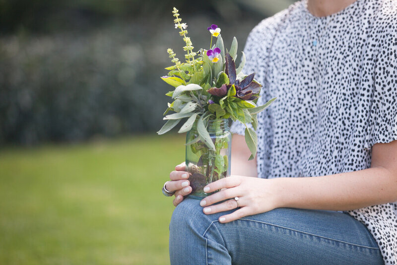 Lauren holding a jar crammed full of the most wonderful array of herbs