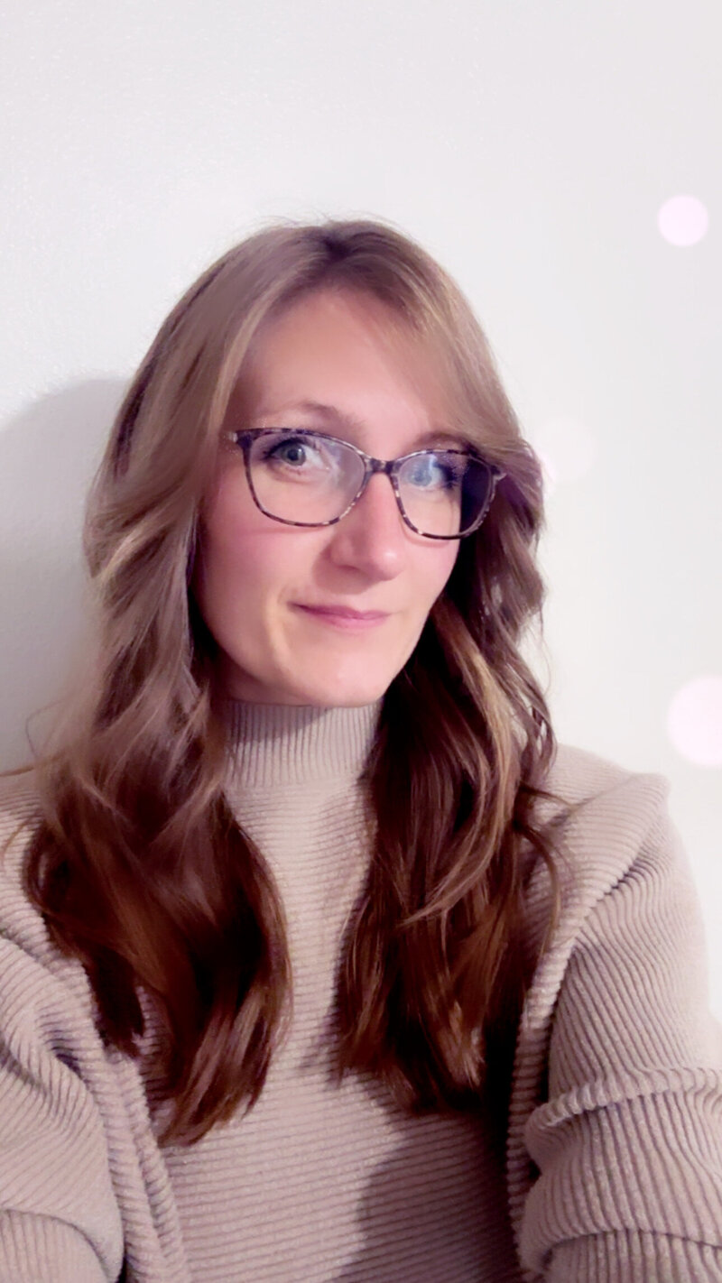 Jazzmine a hair stylist in Eugene smiles at the camera.