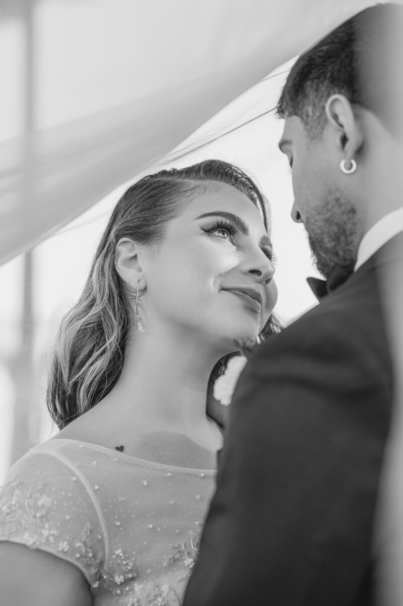 Bride Gazes Lovingly at Groom, Smiling with Affection